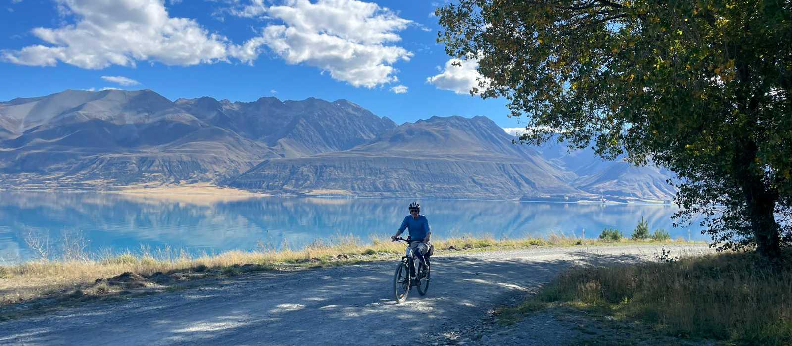Cycling along Lake Pukaki on the Alps to Ocean End to End with Adventure South. | Guide Collie