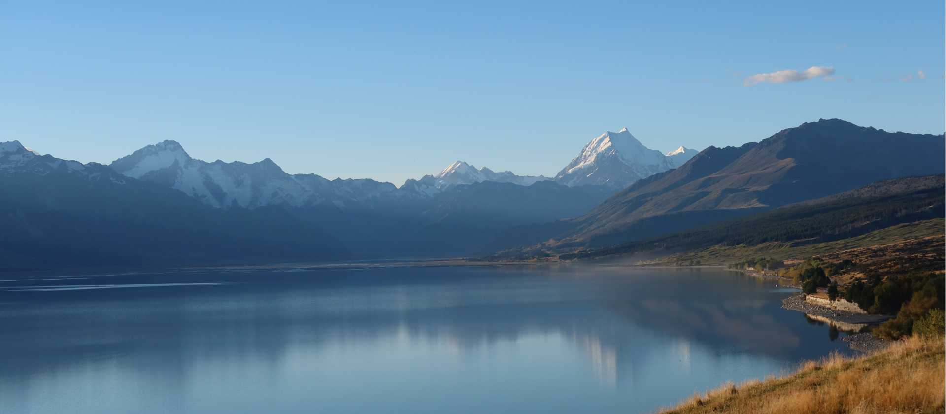 Cycling along Lake Pukaki on the Alps to Ocean End to End with Adventure South. | Guide Collie