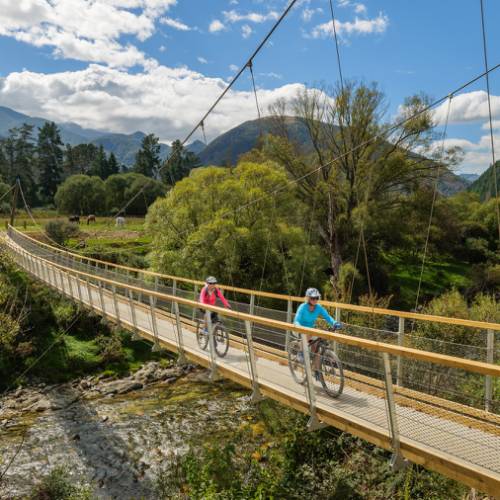 A purpose-built suspension bridge takes us across the pretty Baton River