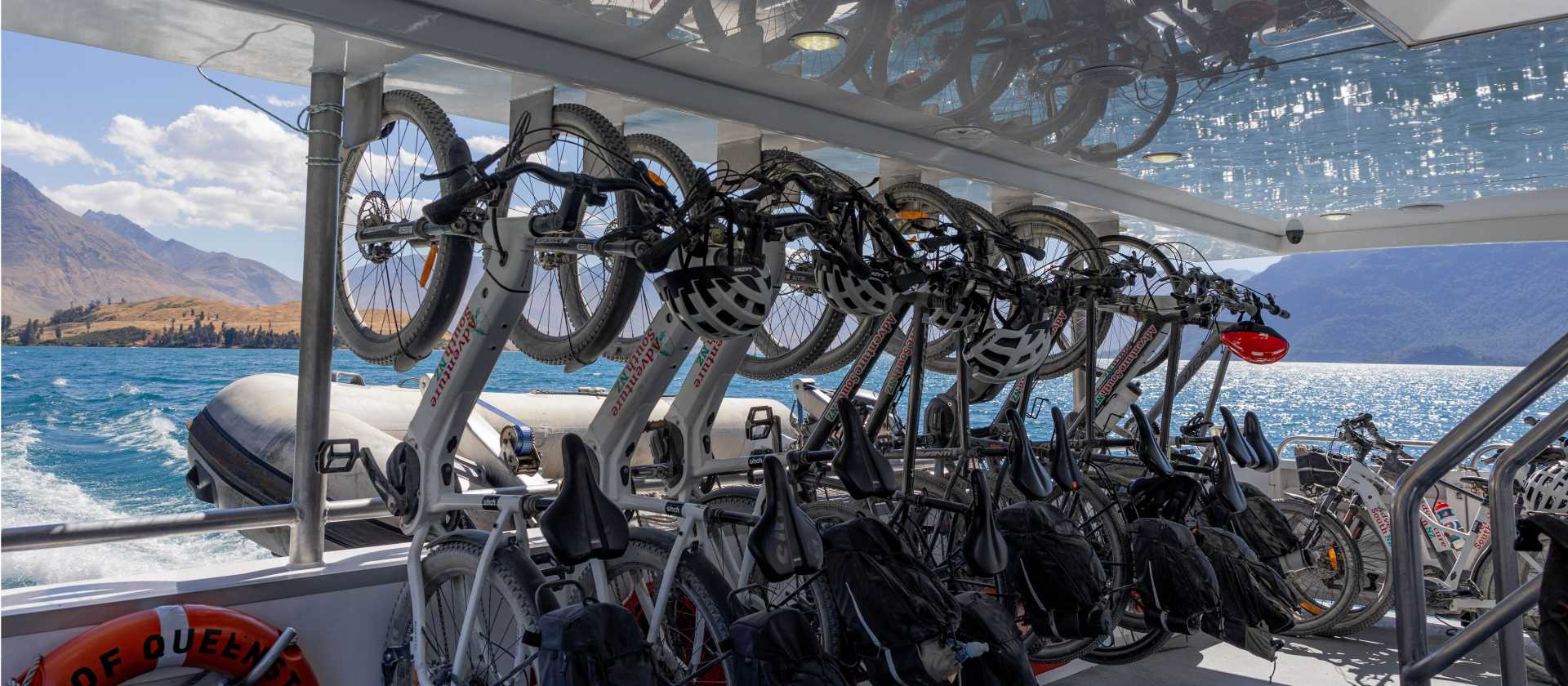 Adventure South bikes lined up in vertical racking aboard the Real NZ ferry from Walter Peak Station to Queenstown at the end of the Around the Mountains cycle trail. | Izzi Barton