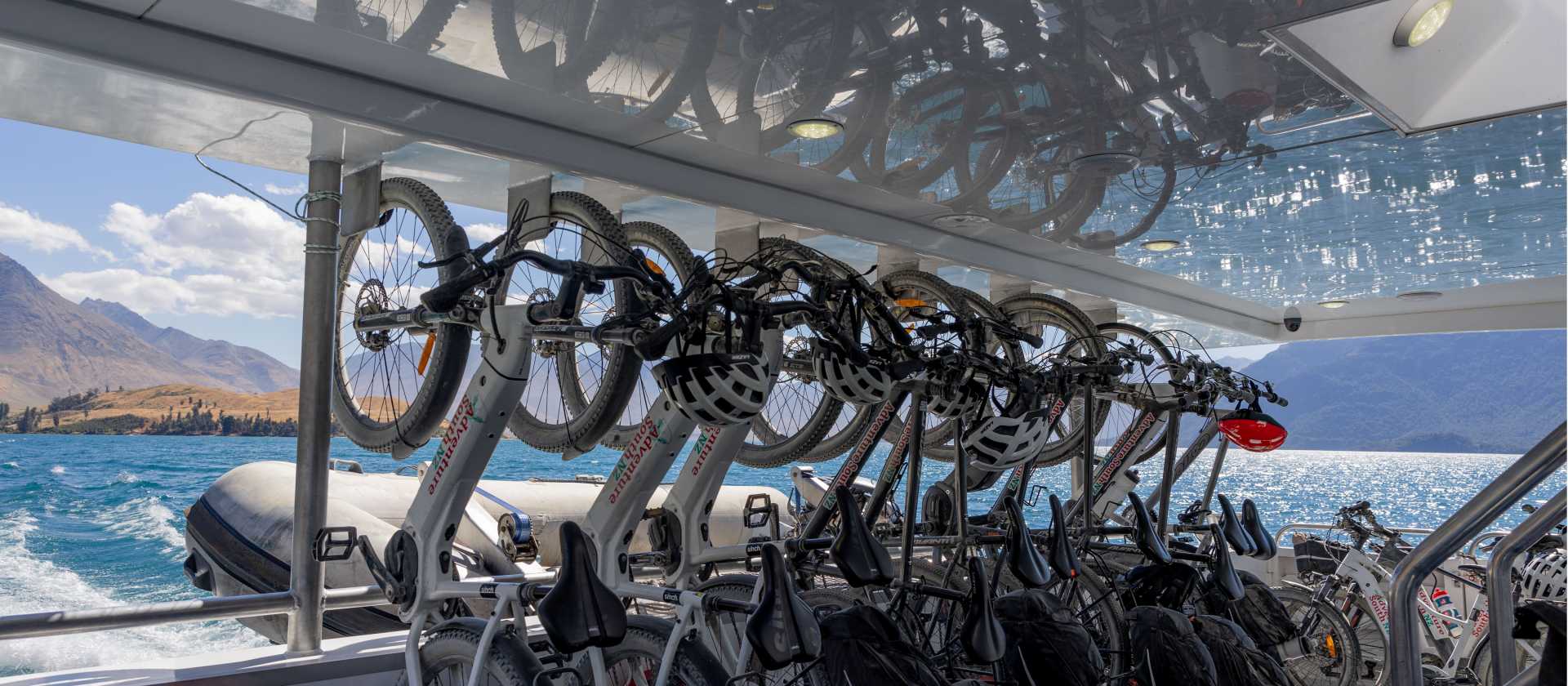 Adventure South bikes lined up in vertical racking aboard the Real NZ ferry from Walter Peak Station to Queenstown at the end of the Around the Mountains cycle trail. | Izzi Barton