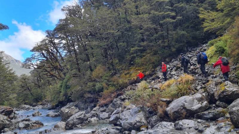 An array of red rain jackets in Goat Pass |  <i>Adventure South NZ</i>