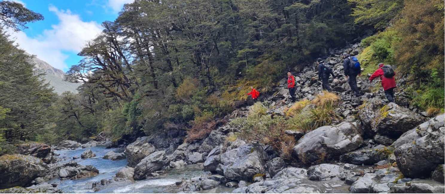 An array of red rain jackets in Goat Pass | Adventure South NZ