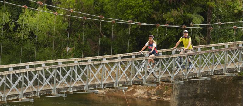 Crossing a sturdy bridge on the Hauraki Cycle Trail