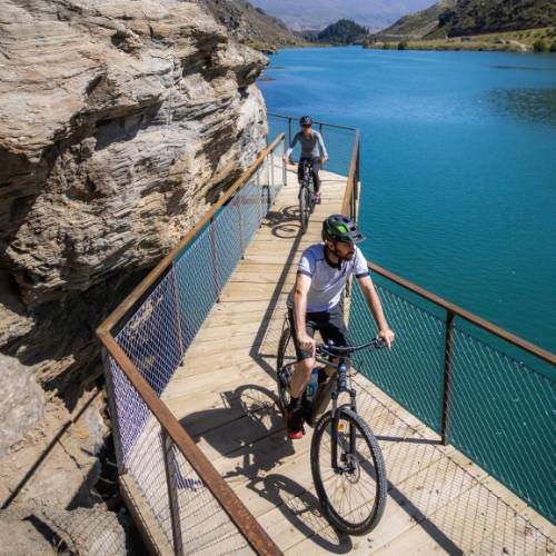 Cyclists riding by Lake Dunstan