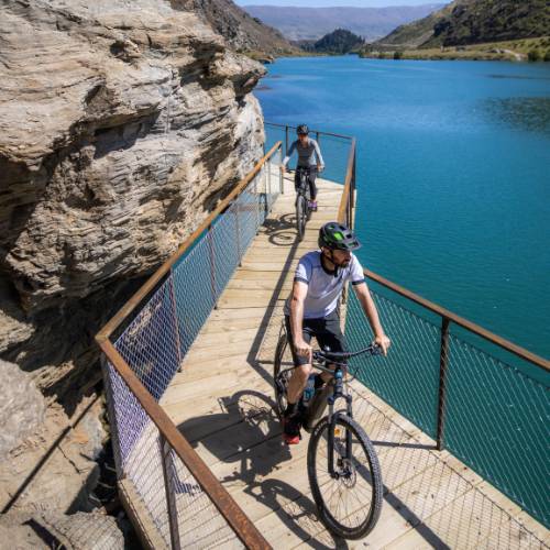 Cyclists riding by Lake Dunstan