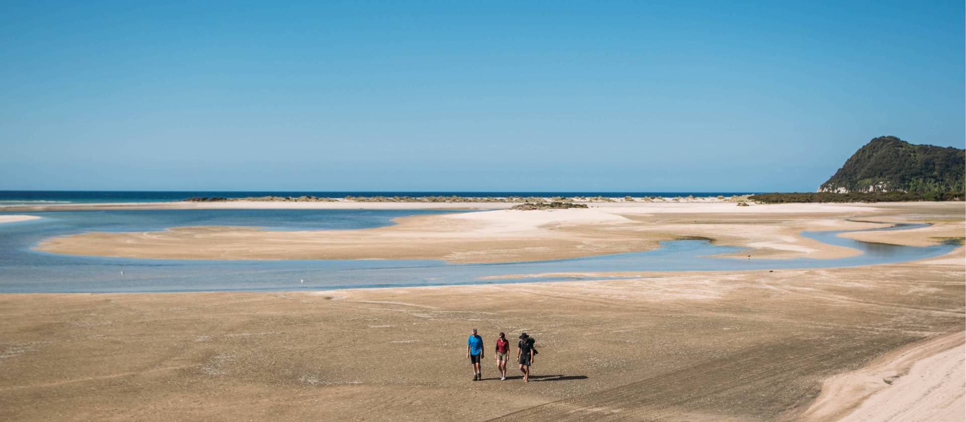 Walking Awaroa Beach at low tide