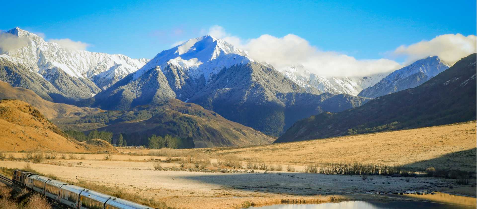 Glide through the towering Tiritiri-o-te-moana / Southern Alps aboard the TranzAlpine — a spectacular prelude to your West Coast cycling journey. | Jay French