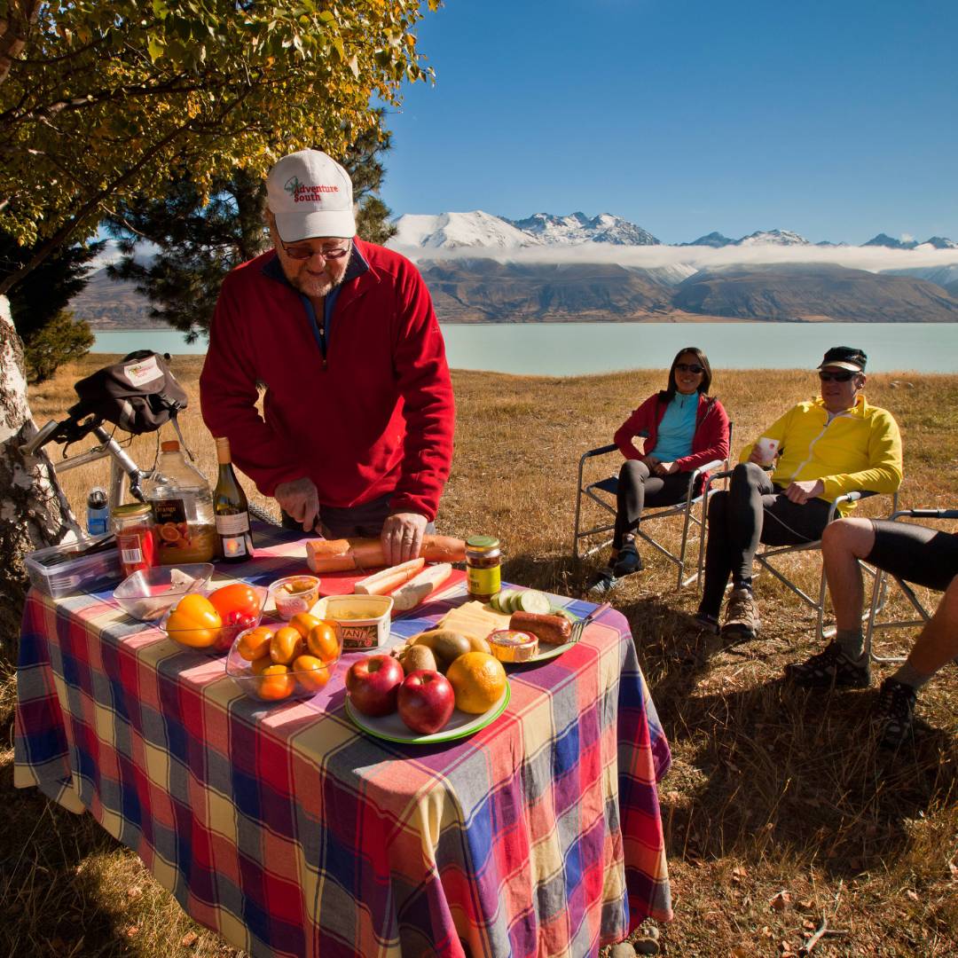 Cyclists about to tuck into a fab lunch prepared by Geoff | Colin Monteath