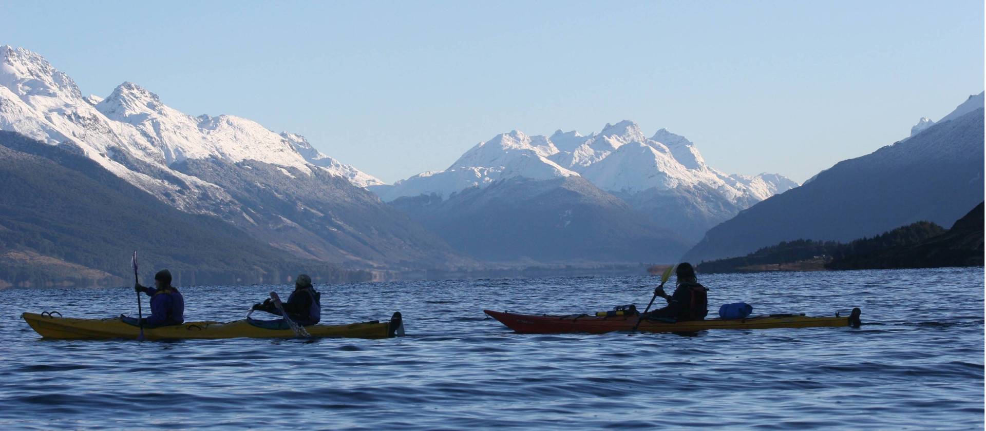 Kayaking on Lake Wakatipu beneath snow capped mountains | Rippled Earth