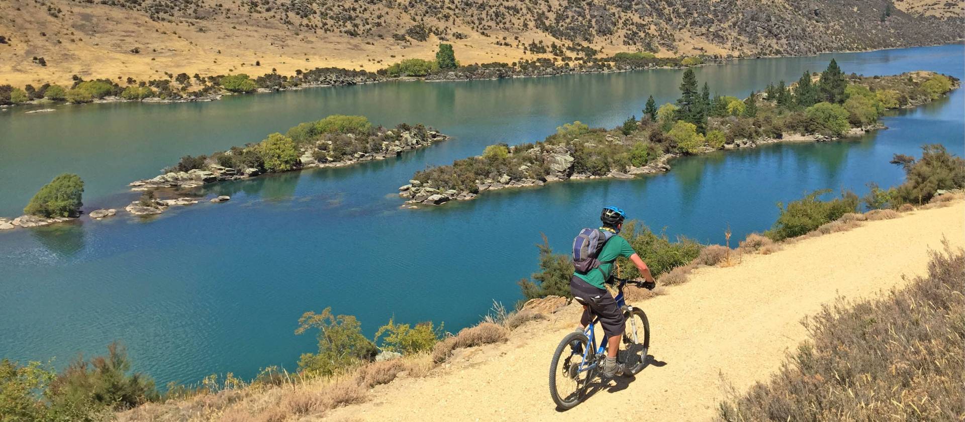 Cycling high above Lake Roxburgh | bennettandslater.co.nz