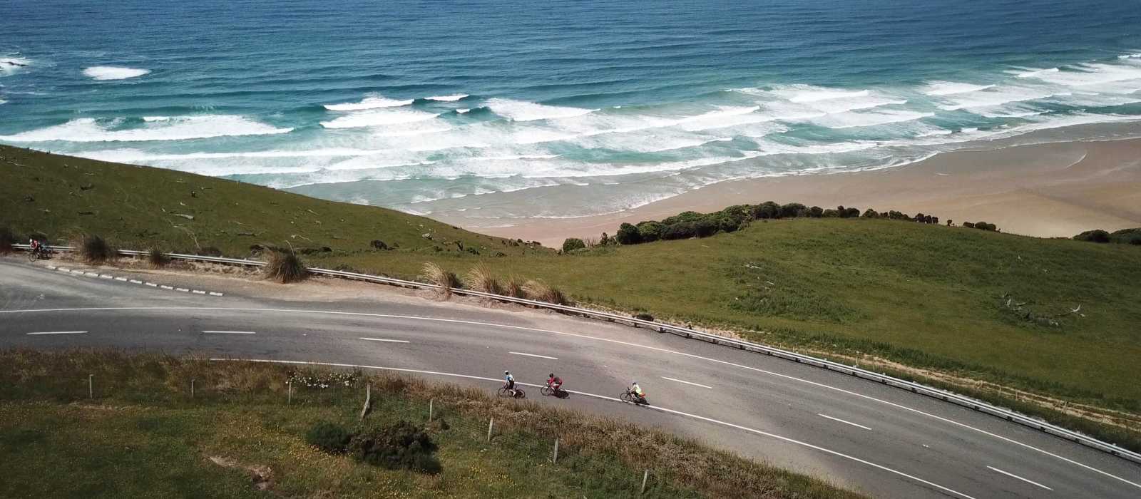 Road cyclists making their way around Papatowai Beach | Reiner Schuster