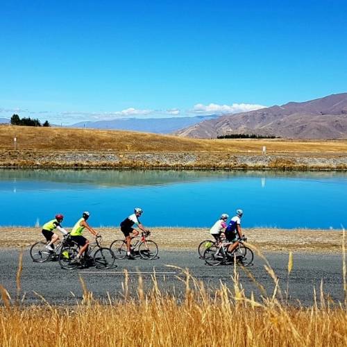 Cycling group enjoying views of the turquoise Hydro-Canals near Twizel.