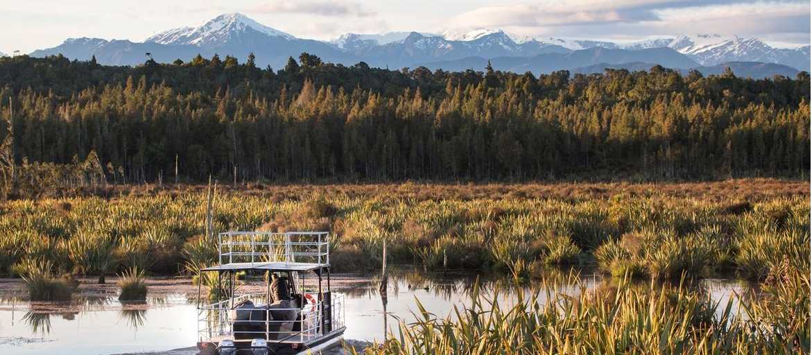 Experience the serene beauty of the Lake Mahinapua waterways on a sunset cruise | Lake Mahinapua Scenic Waterways