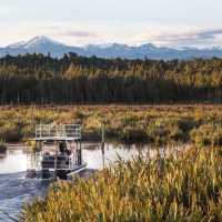 Experience the serene beauty of the Lake Mahinapua waterways on a sunset cruise | Lake Mahinapua Scenic Waterways