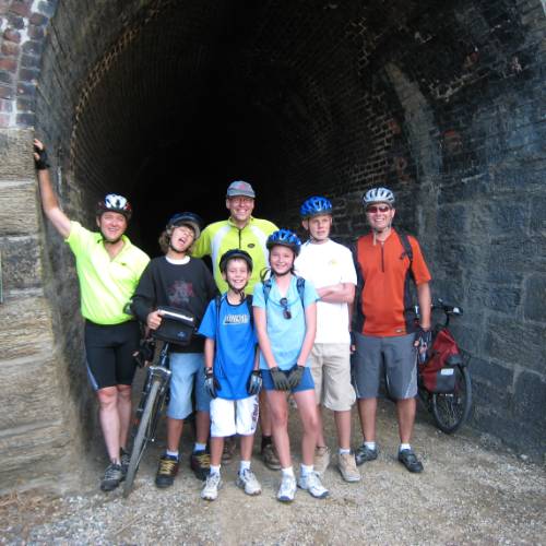 Family pose at Tunnel on Otago Rail Trail family tour